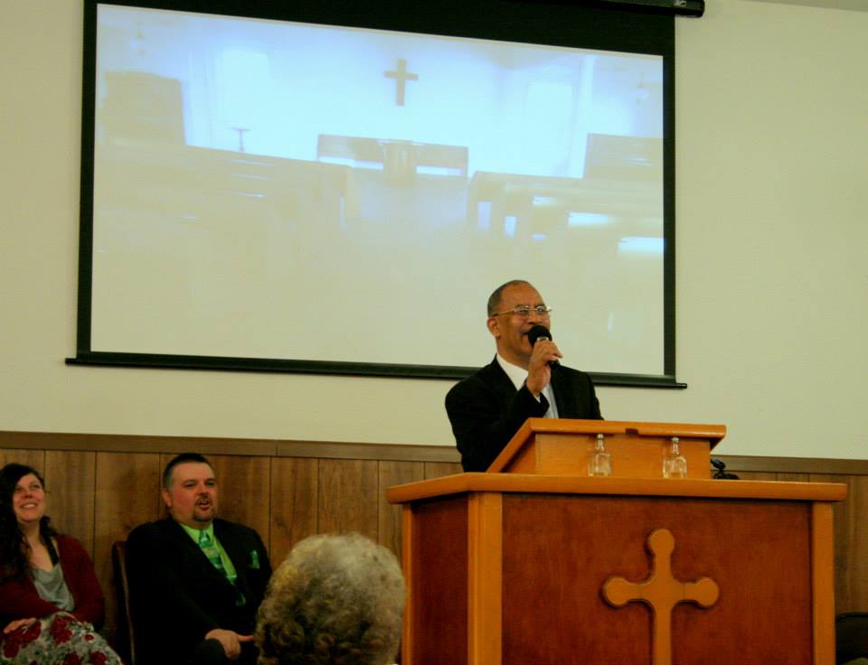 Pastor speaking at Willow River Gospel Chapel during a worship service